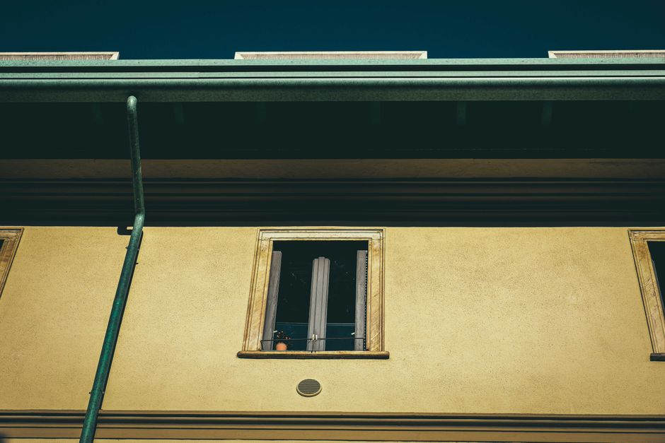 Gutter clearing equipment being used from ground level on a house